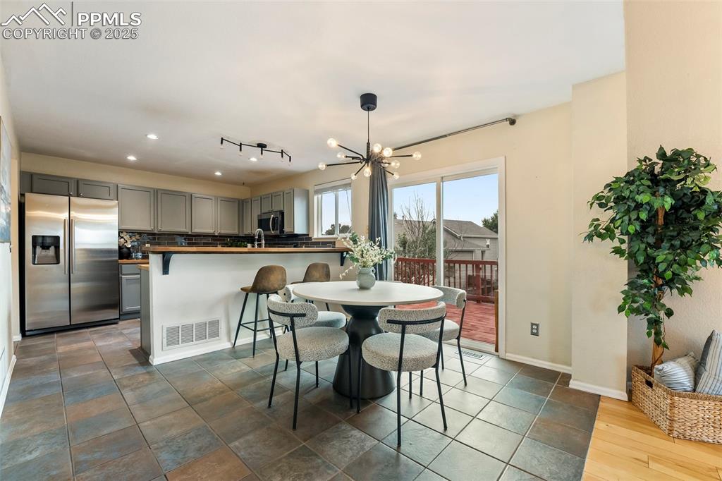 Image 9 of 31: Dining room with a chandelier and recessed lighting