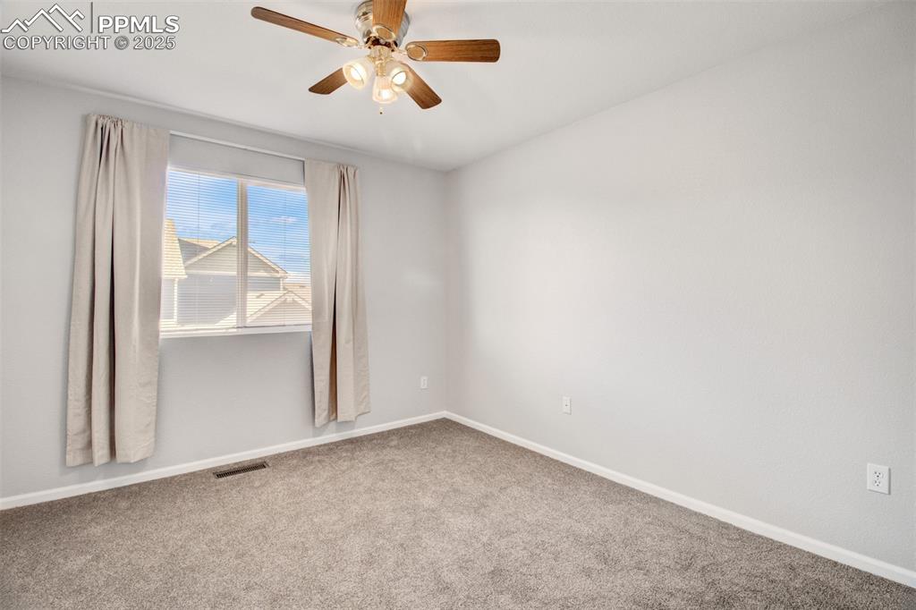 Image 10 of 24: Second bedroom with ceiling fan, new carpet and blinds
