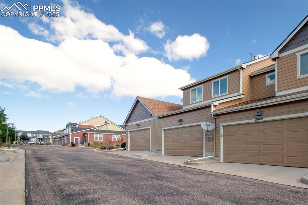Image 14 of 24: View of asphalt road featuring a residential view