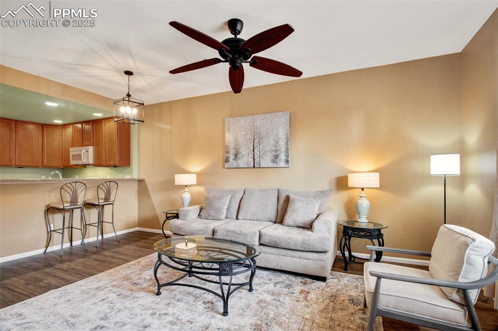 Image 17 of 24: Another view of the living room featuring new flooring and all furnishings,
