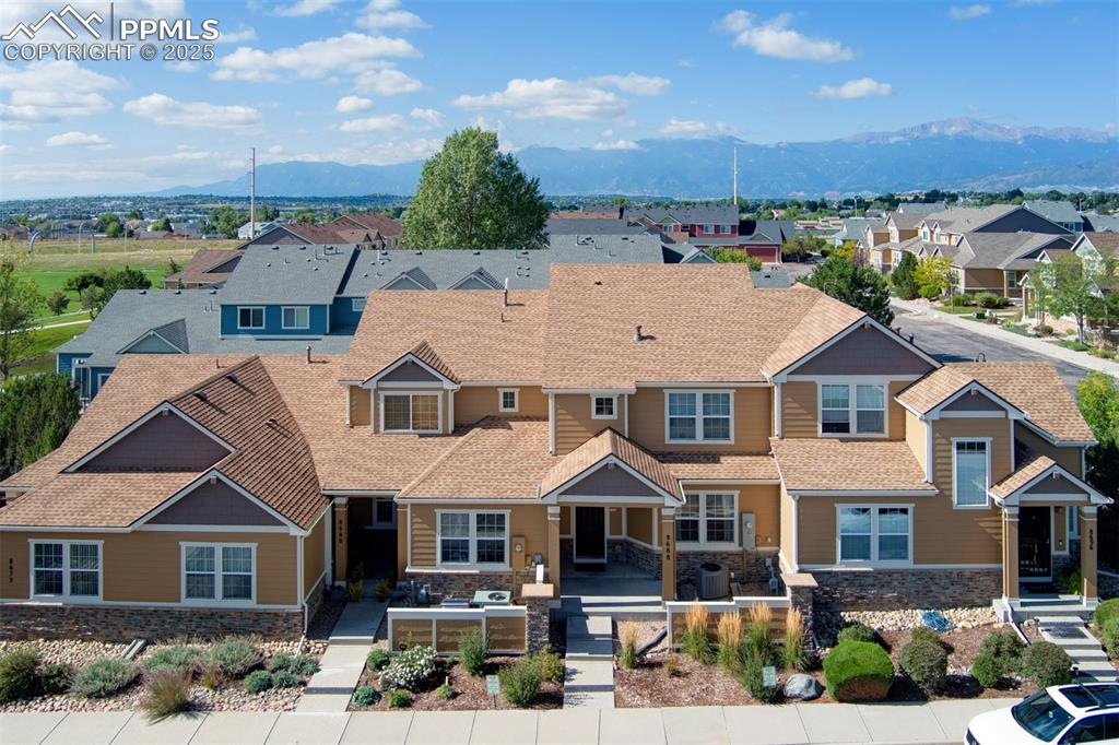 Image 23 of 24: Aerial perspective of suburban area featuring mountains
