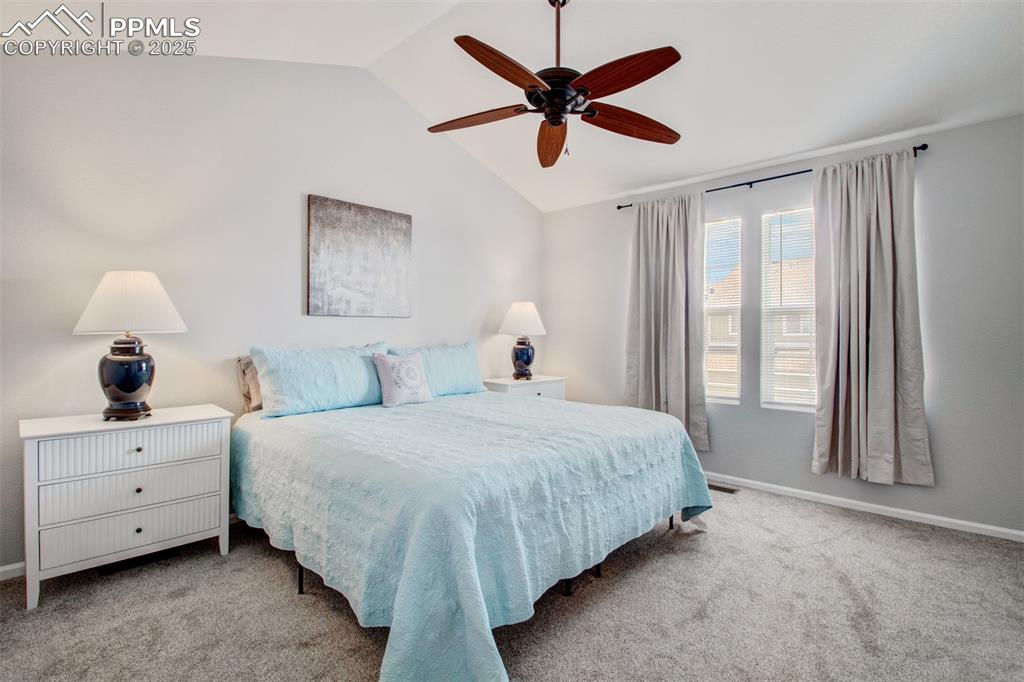 Image 6 of 24: Primary bedroom featuring vaulted ceiling, new carpeted floors, ceiling fan