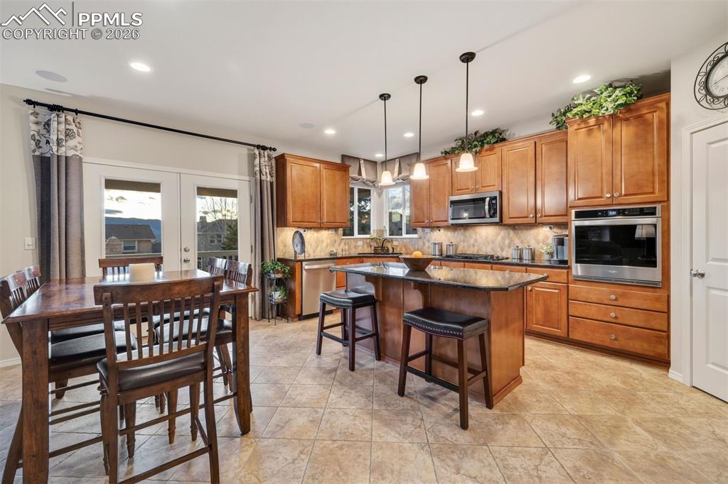 Image 12 of 50: Walk out to the covered rear deck 