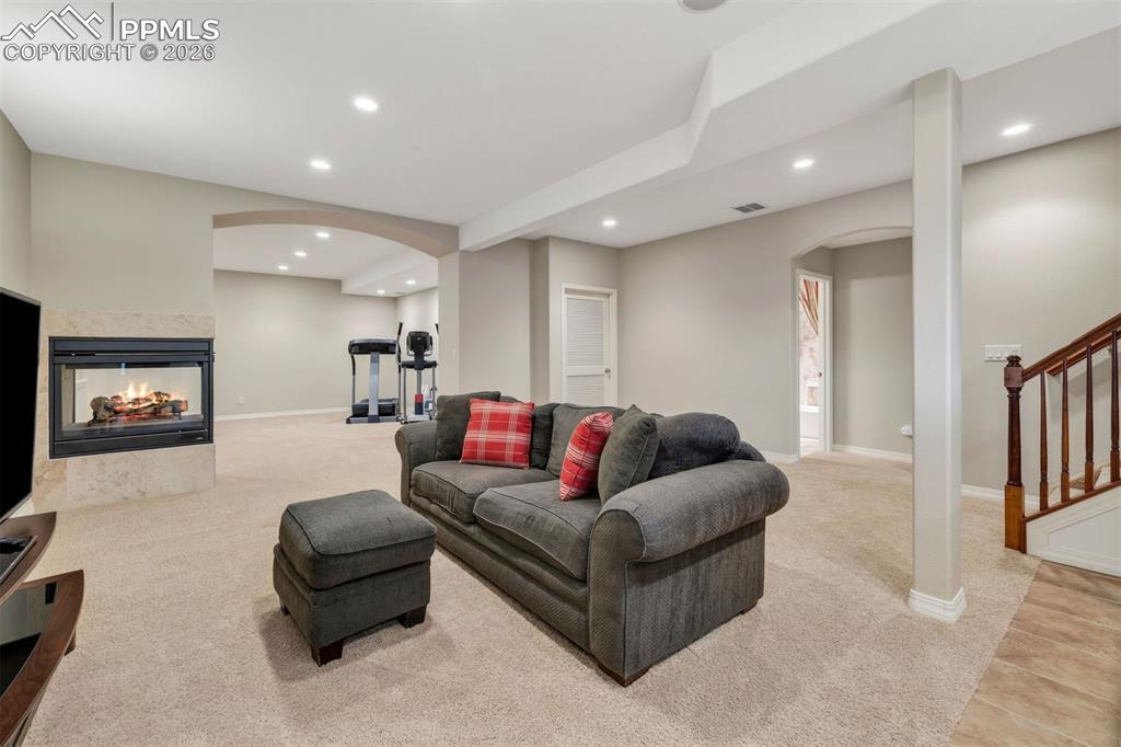 Image 35 of 50: Another gas fireplace makes the basement warm and cozy