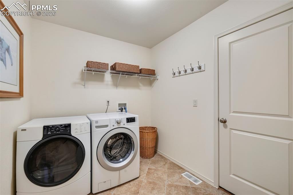 Image 41 of 50: main level laundry room with spacious coat closet