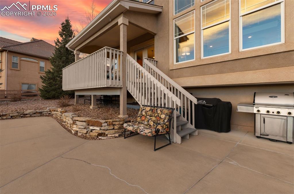 Image 45 of 50: Rear deck and an extended concrete patio 