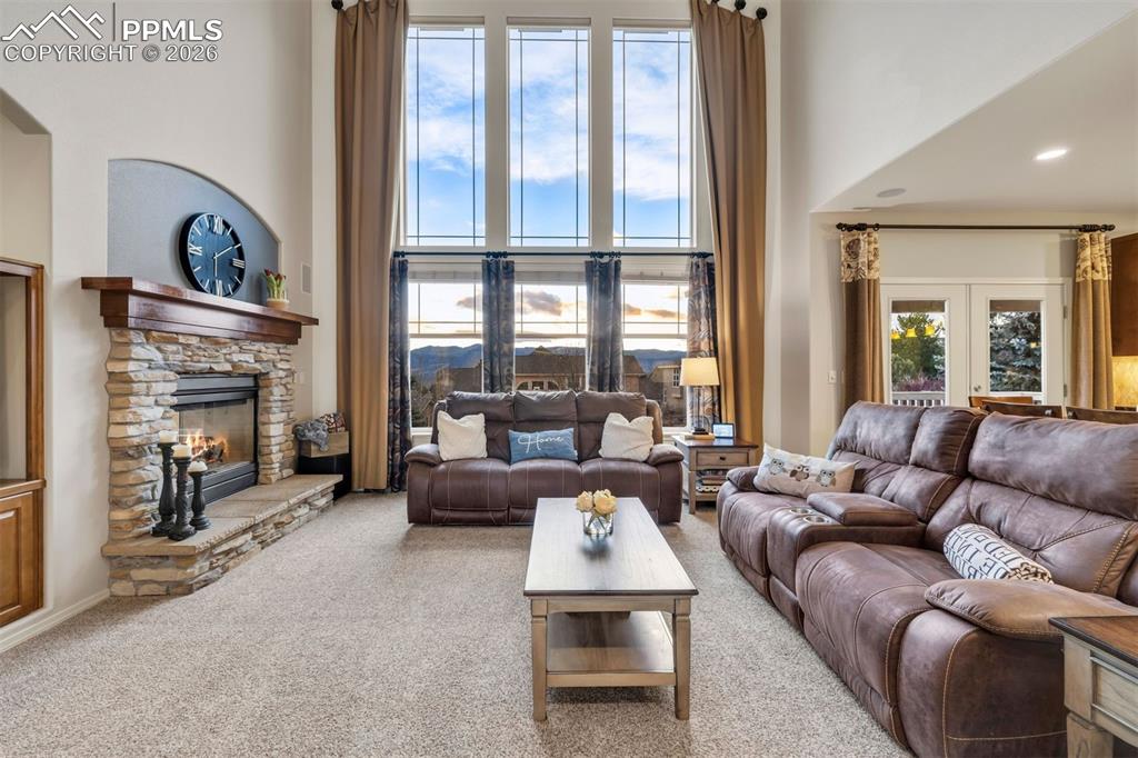 Image 9 of 50: A gas burning fireplace, wood mantle and raised hearth 