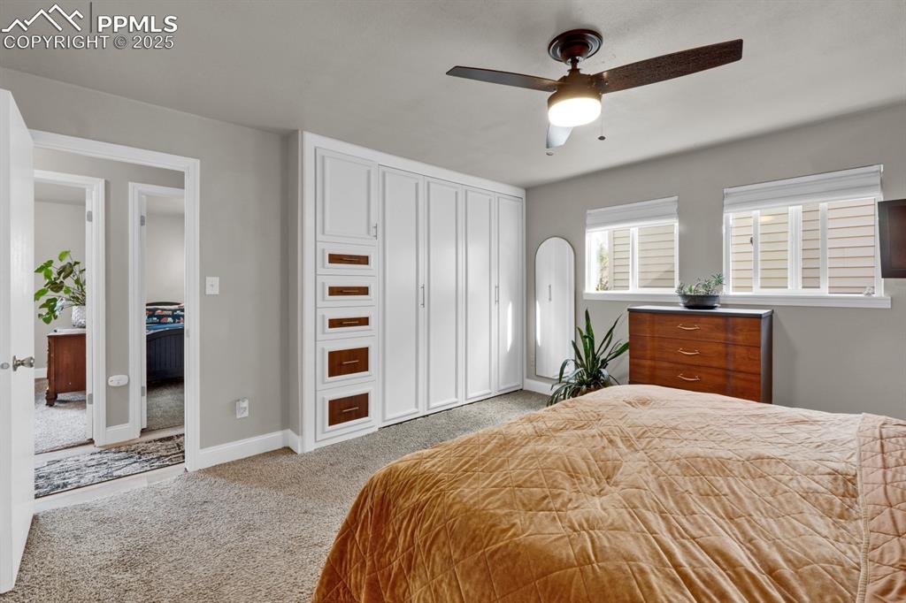 Image 17 of 34: Carpeted bedroom featuring arched walkways, a closet, a ceiling fan, and ba