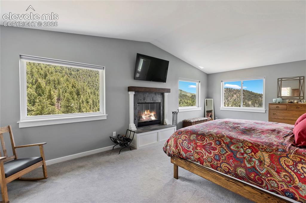 Image 18 of 31: Primary bedroom with views from every window!