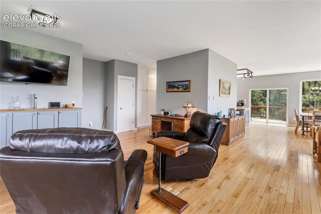 Image 8 of 31: Great layout and room for relaxing, watching TV, a desk area and a wet bar