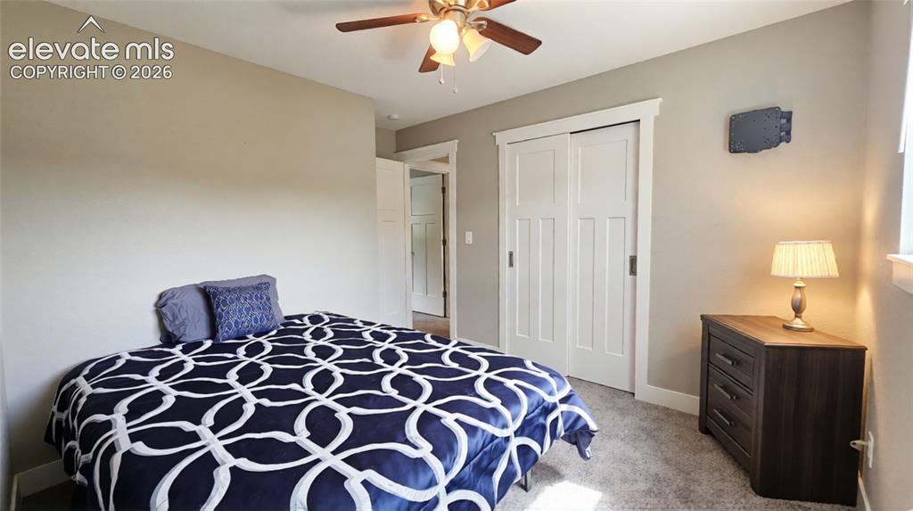 Image 16 of 31: Carpeted flooring and a ceiling fan