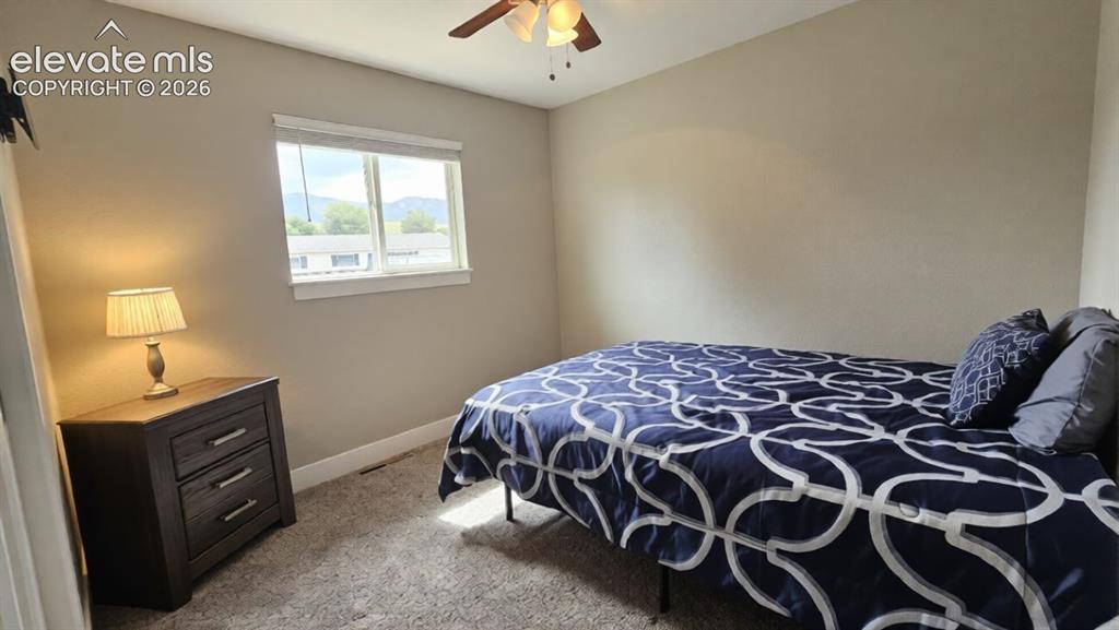 Image 17 of 31: Carpeted flooring and a ceiling fan