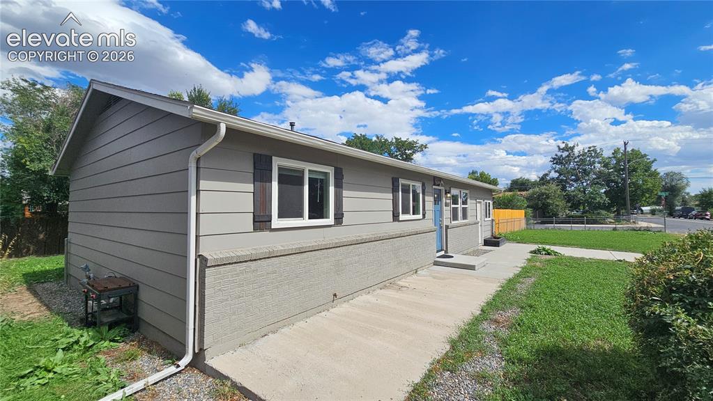 Image 2 of 31: Single-story residence featuring horizontal siding and brick siding