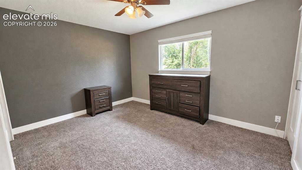 Image 23 of 31: Neutral wall paint, white trim, and carpeted flooring