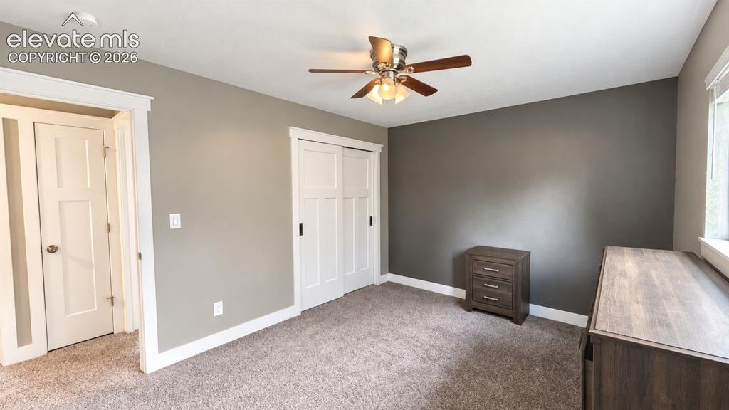 Image 24 of 31: Neutral wall paint, white trim, and carpeted flooring