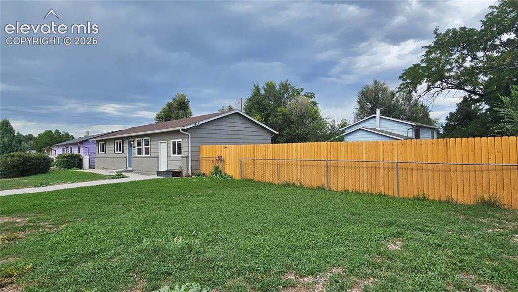 Image 28 of 31: Single-story residence featuring horizontal siding and brick siding, on a l