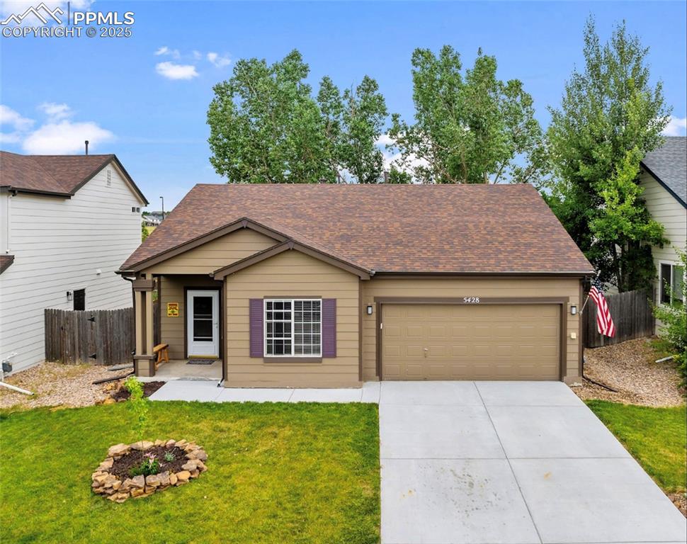 Caption: View of front of house with a garage, concrete driveway, and roof with shingles