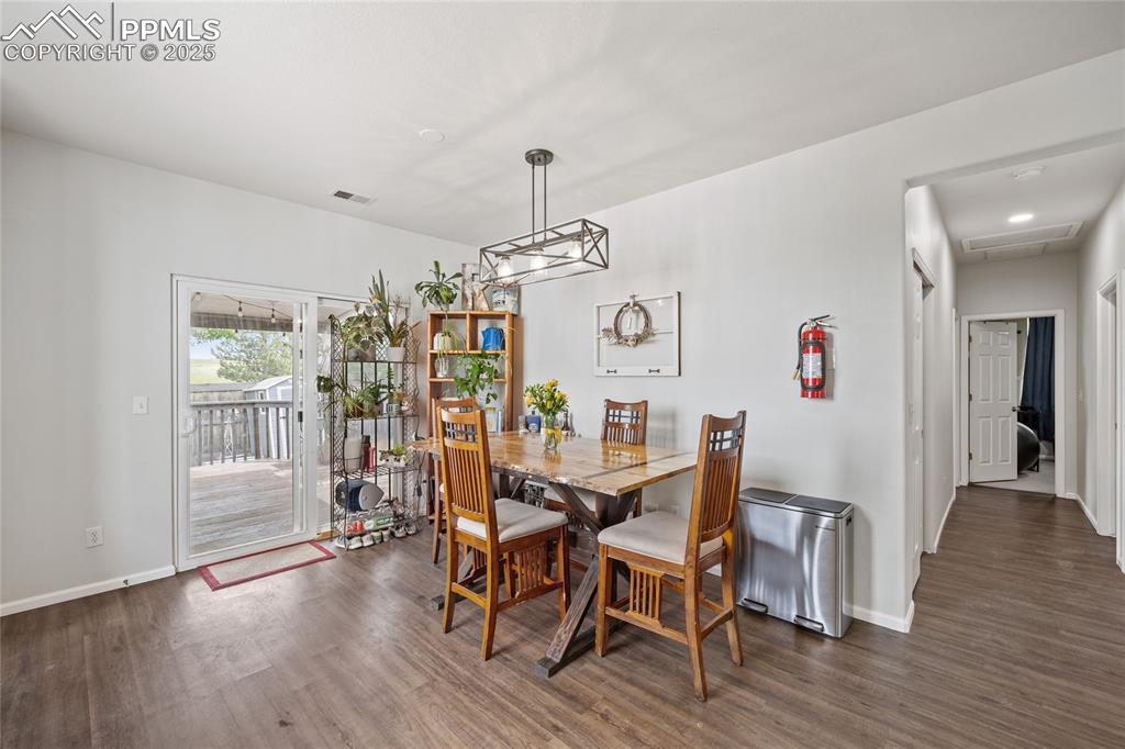 Image 12 of 44: Dining space with wood finished floors and baseboards
