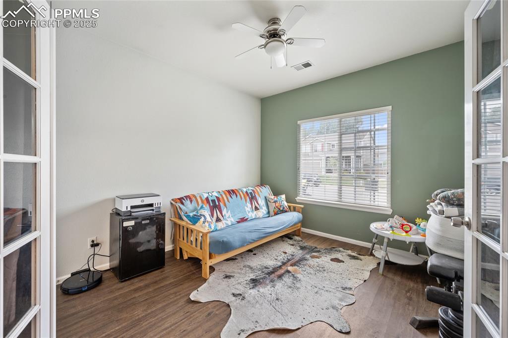Image 13 of 44: Bedroom with wood finished floors, baseboards, and a ceiling fan