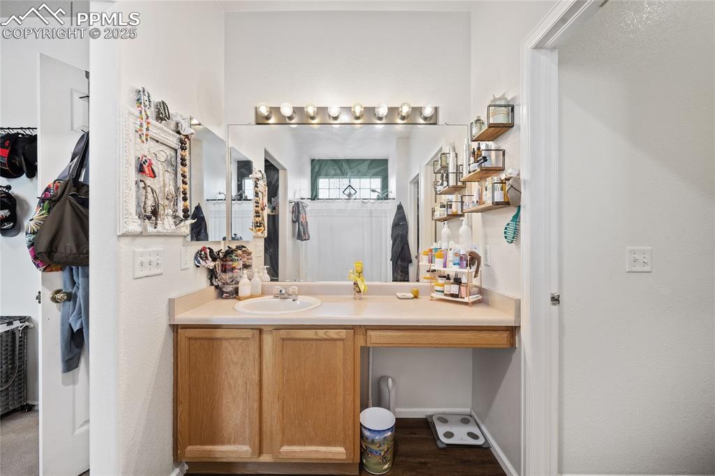 Image 19 of 44: Full bath featuring vanity, wood finished floors, and curtained shower