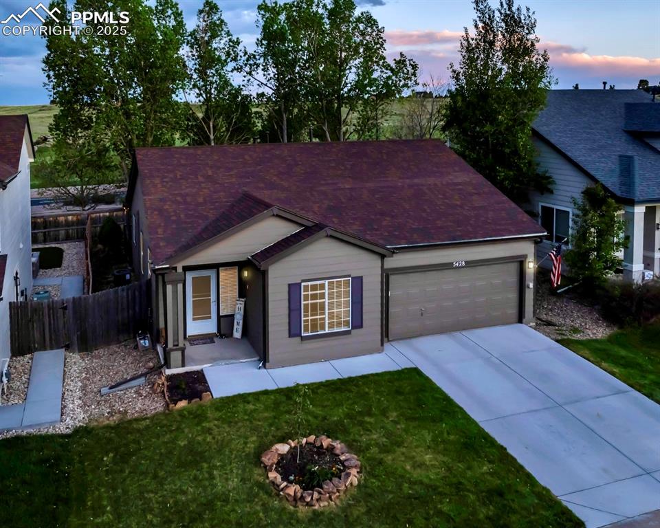 Image 2 of 44: Ranch-style house with an attached garage, concrete driveway, and a shingle