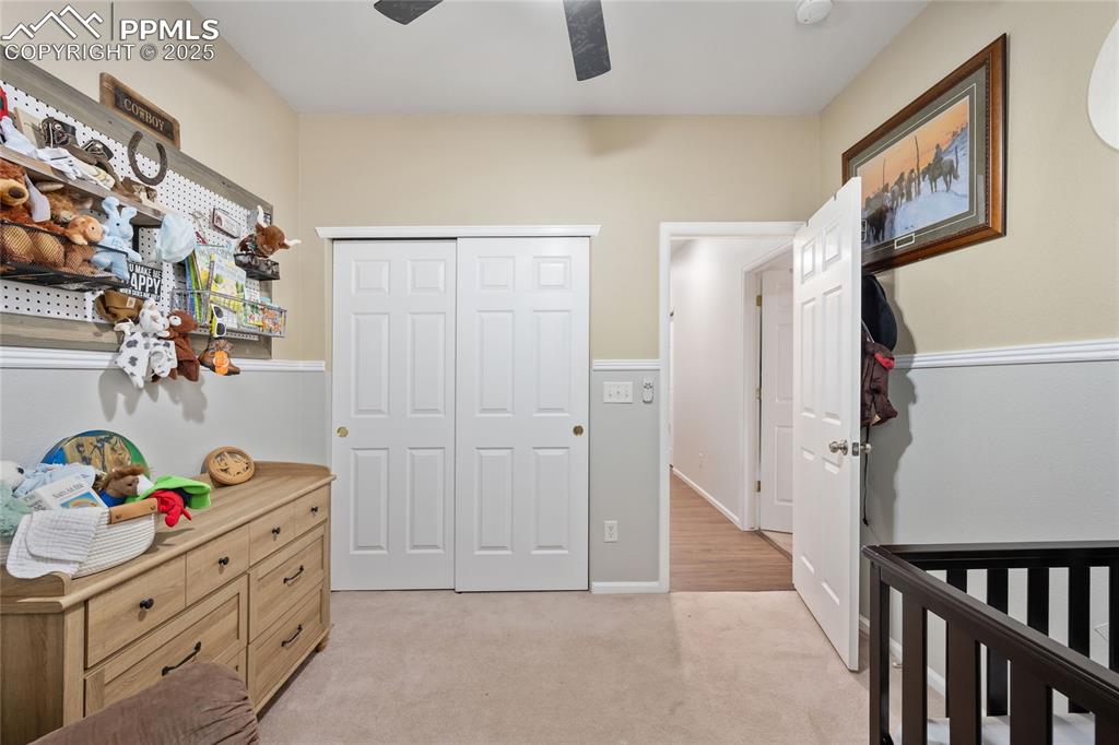 Image 23 of 44: Bedroom featuring light colored carpet, a closet, and ceiling fan