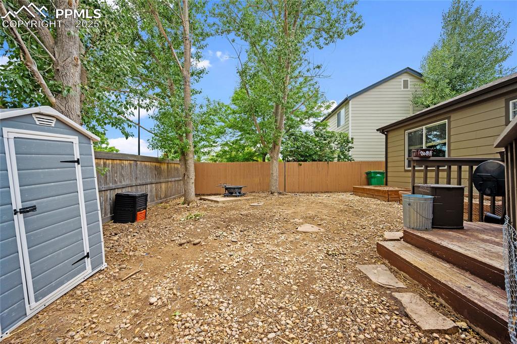 Image 27 of 44: View of fenced backyard
