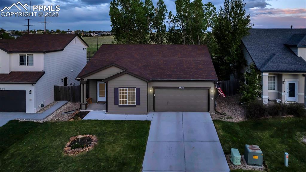 Image 29 of 44: View of front of house featuring concrete driveway and an attached garage