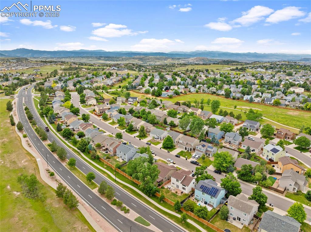 Image 37 of 44: Aerial perspective of suburban area with a mountain backdrop
