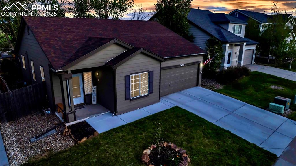 Image 4 of 44: View of front of home with concrete driveway, an attached garage, and roof 