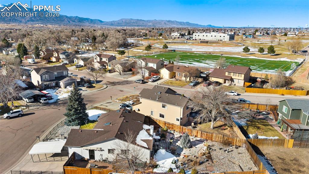 Image 4 of 48: beautiful park and turf field one block away. Widefield rec cent is right t