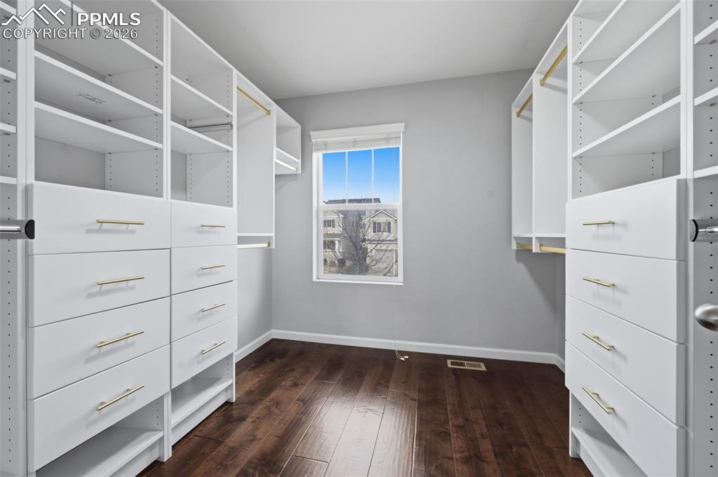 Image 24 of 49: Primary suite custom closet organizer