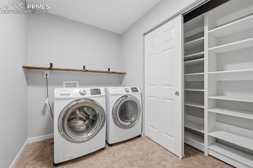 Image 25 of 49: Upstairs laundry with front-loading machines