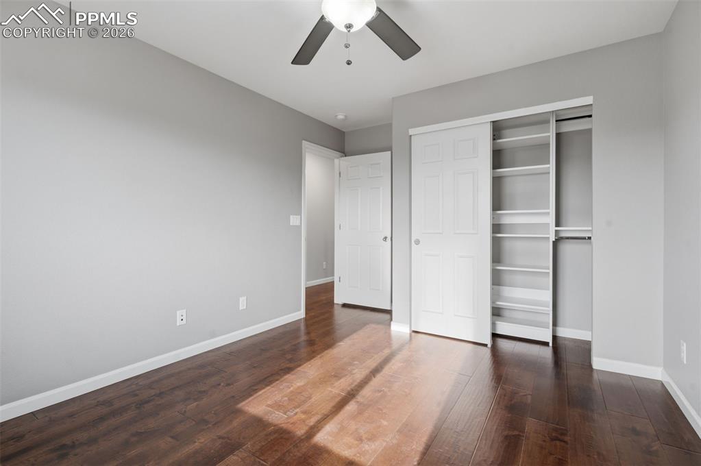 Image 27 of 49: Room featuring rich wood-finish flooring, light gray walls, and white trim