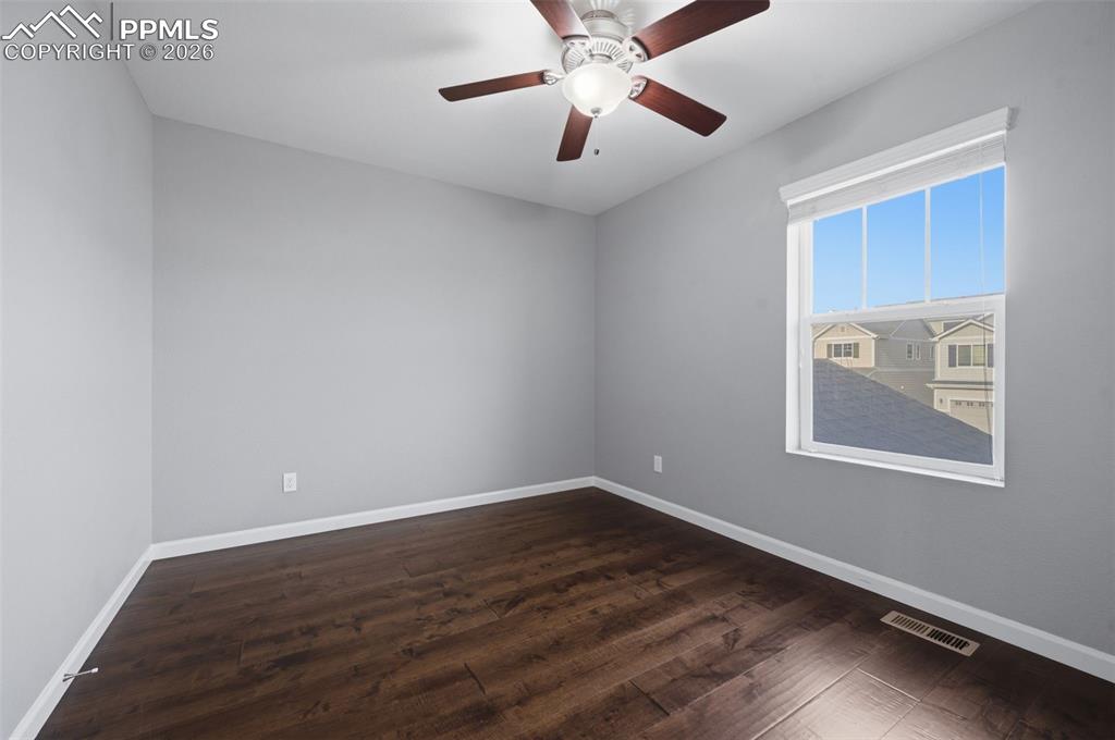 Image 29 of 49: Room featuring wood-finish flooring, light gray walls, white trim, and a ce