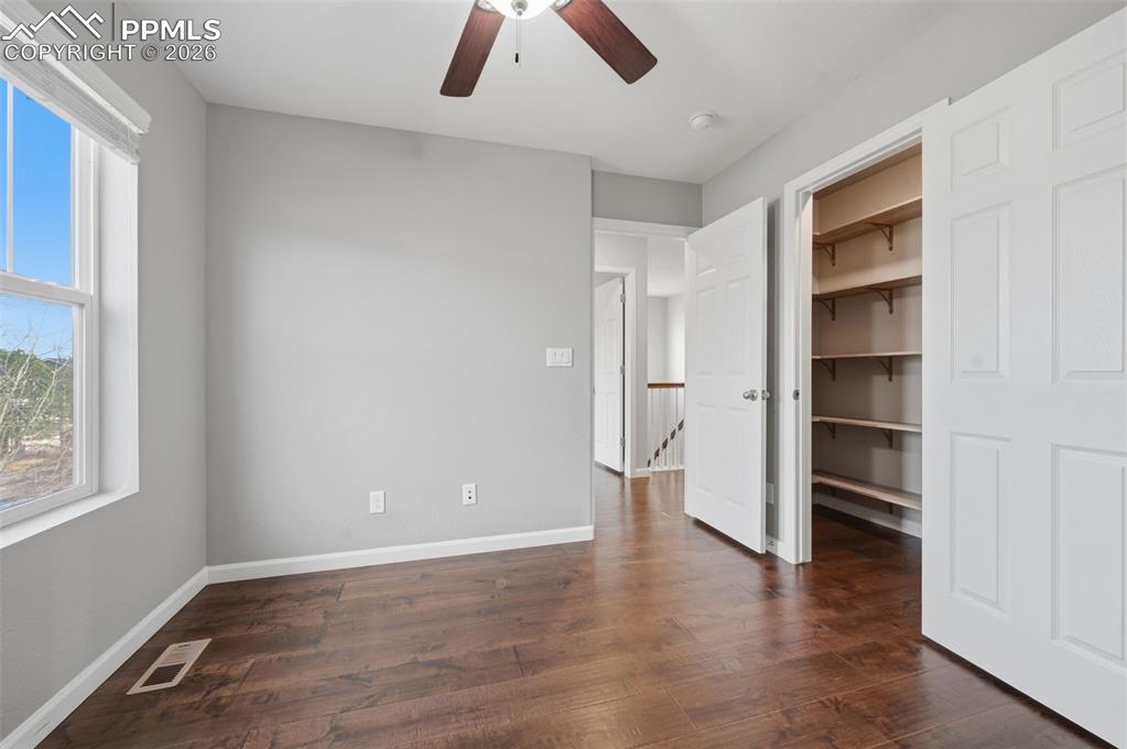 Image 30 of 49: Room featuring dark wood-finish flooring, light gray walls, and a ceiling f