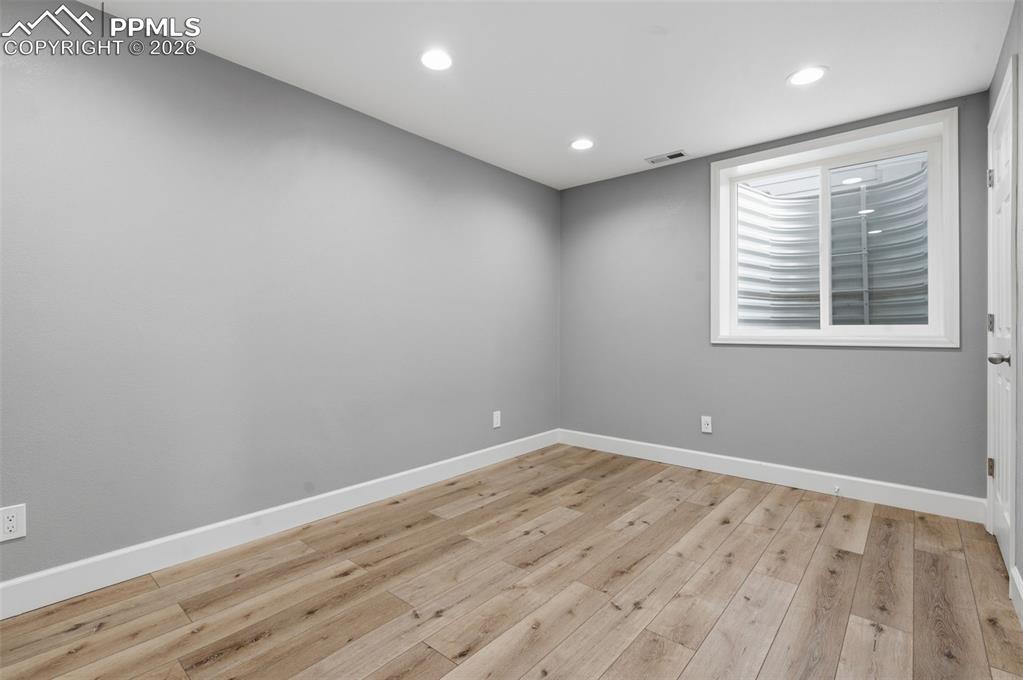 Image 42 of 49: Bonus Room. Non-conforming bedroom,  featuring wood-finish flooring, recess
