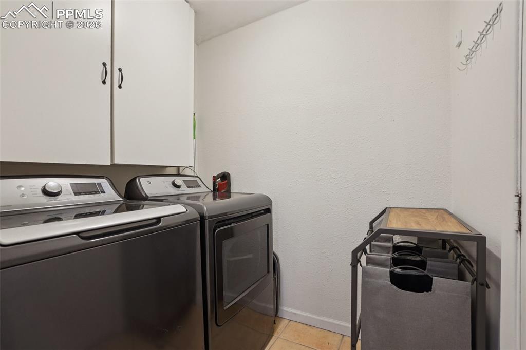 Image 26 of 38: Laundry/mud room off kitchen with access to backyard