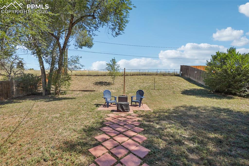 Image 29 of 38: Path to sitting area in the backyard
