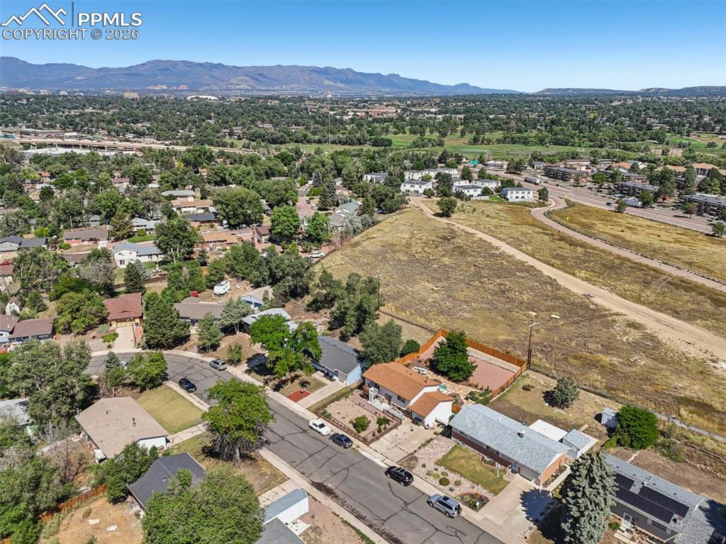 Image 35 of 38: Aerial view of the home with the mountains shining in the background!