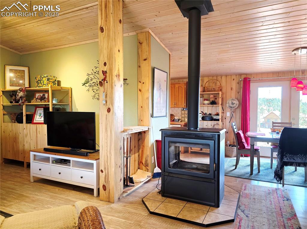 Image 14 of 50: double sided stove between living and dining areaa