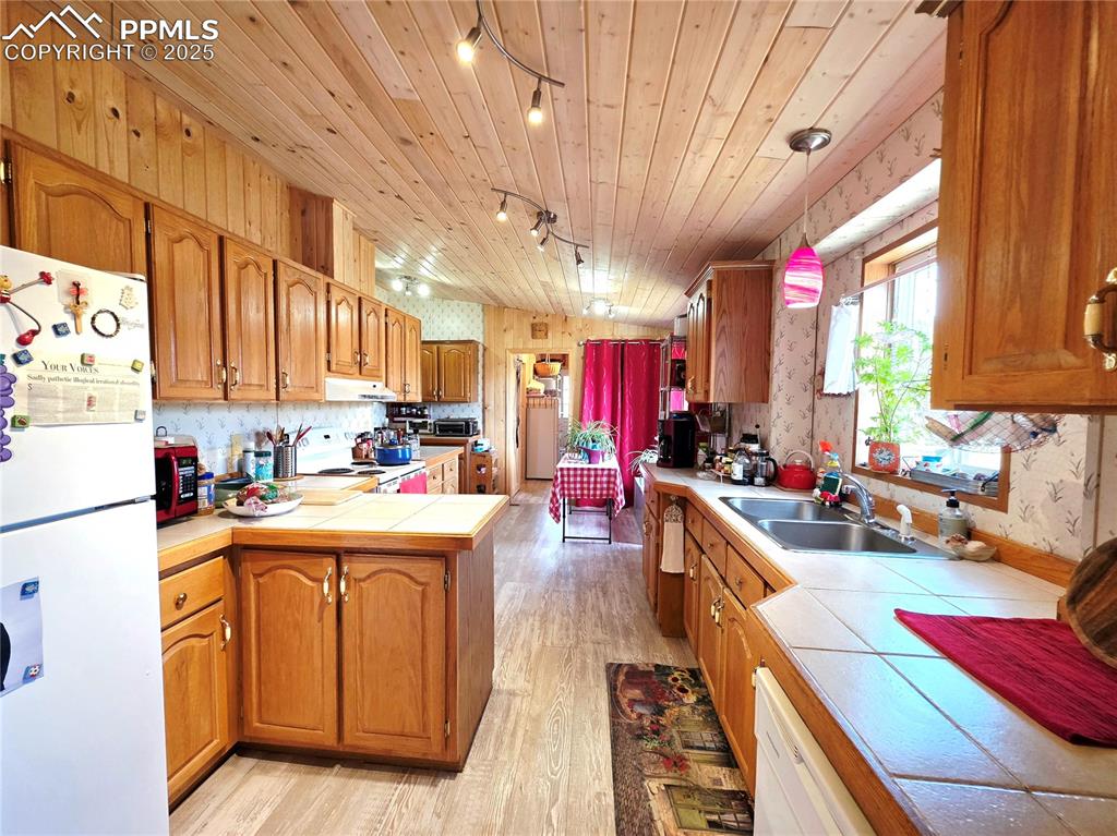 Image 17 of 50: Lots of storage and countertops here in this ilght and bright spacious kitc