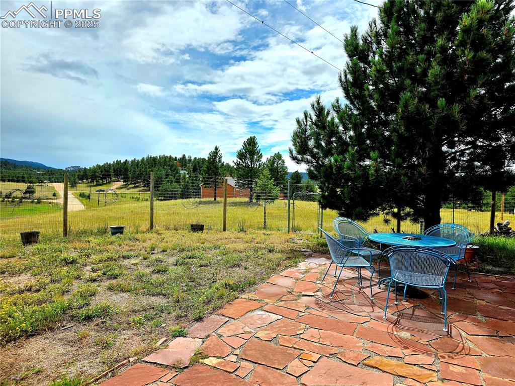 Image 36 of 50: New stone patio in the backyard