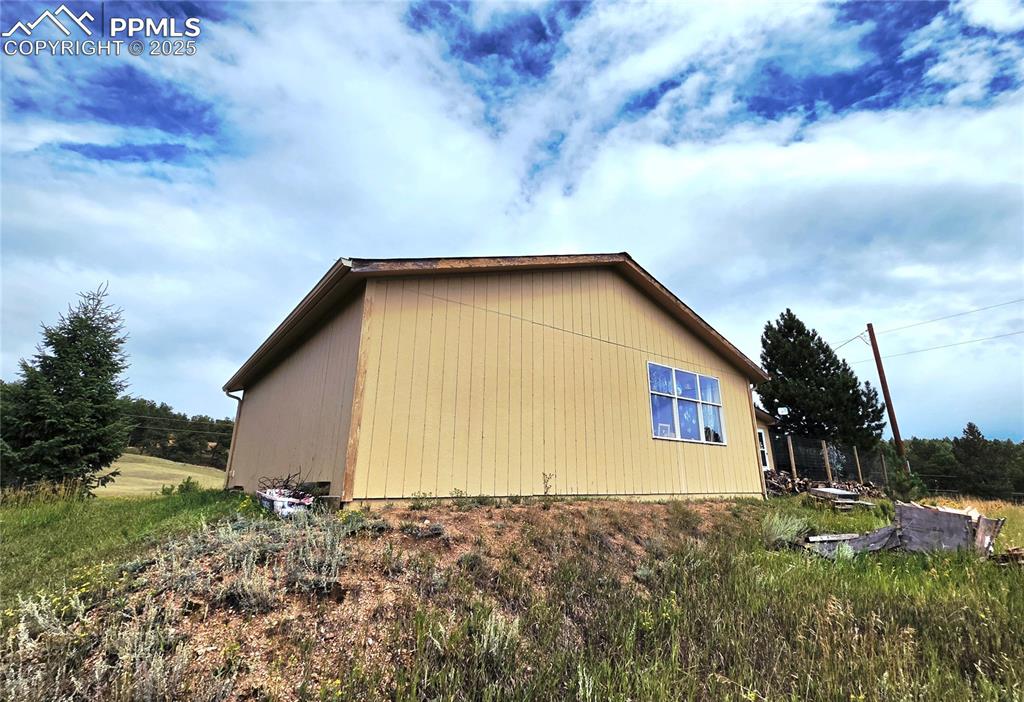 Image 41 of 50: Back of 3 car Garage showing large picture window