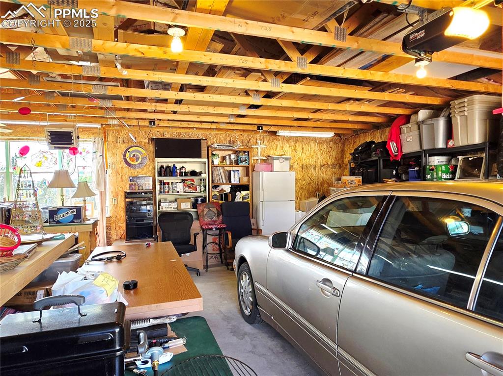 Image 42 of 50: Spacious 3 car garage with sunny picture window
