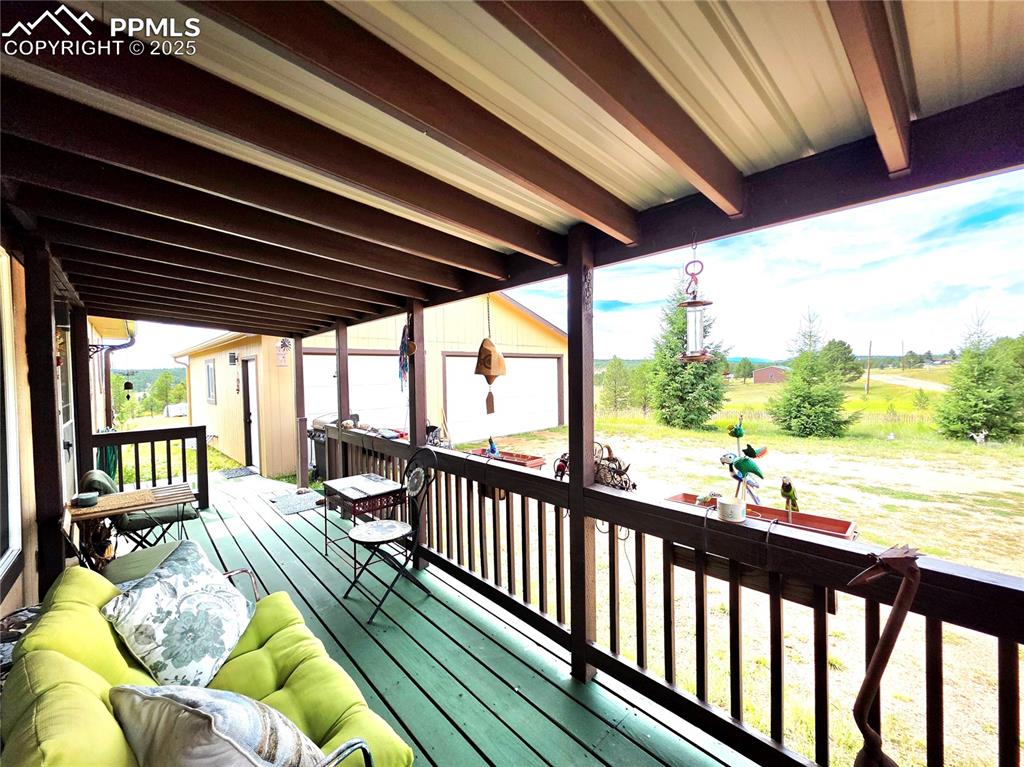 Image 8 of 50: Front of home has nice covered deck