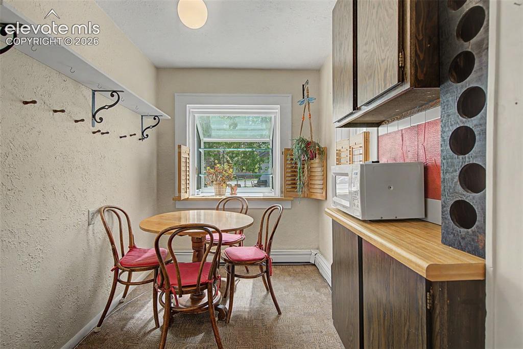 Image 11 of 26: Separate dining area off kitchen area