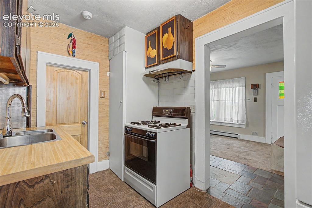 Image 13 of 26: View of kitchen to living room