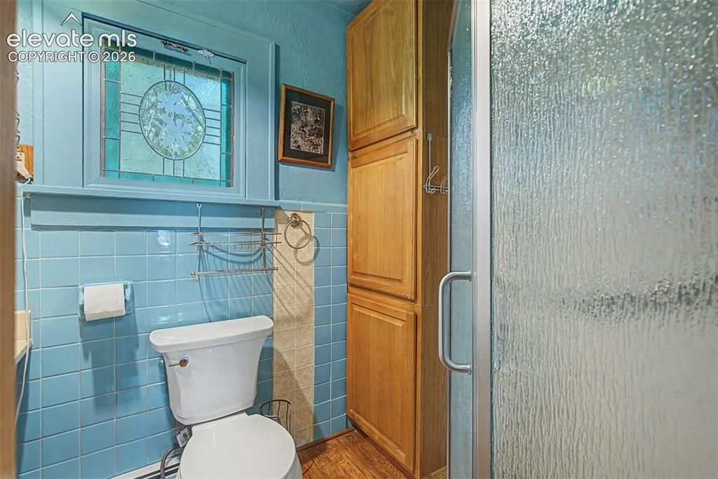 Image 20 of 26: Large linen closet, window, tile accents