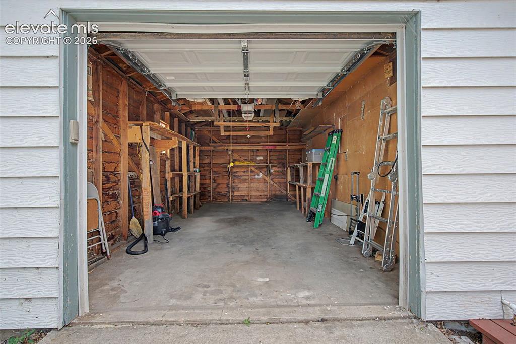 Image 21 of 26: Oversize garage.  Garage door opener with key pad
